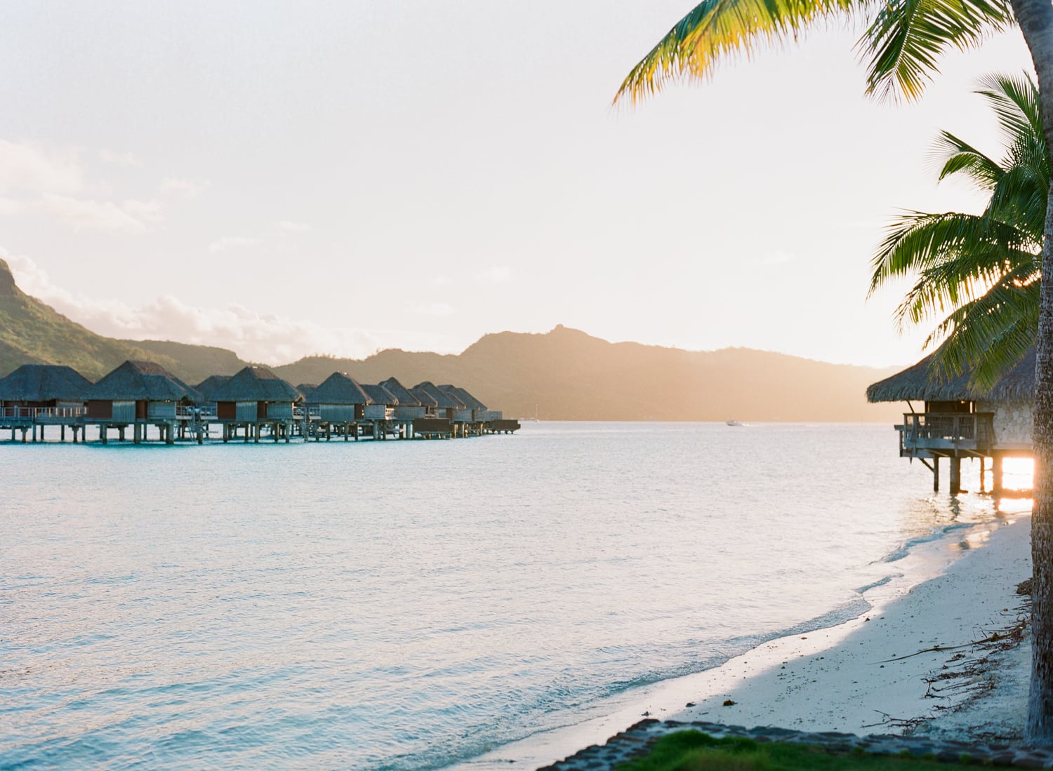 View on the beach and the overwater bungalow at the Four Seasons Bora Bora Resort
