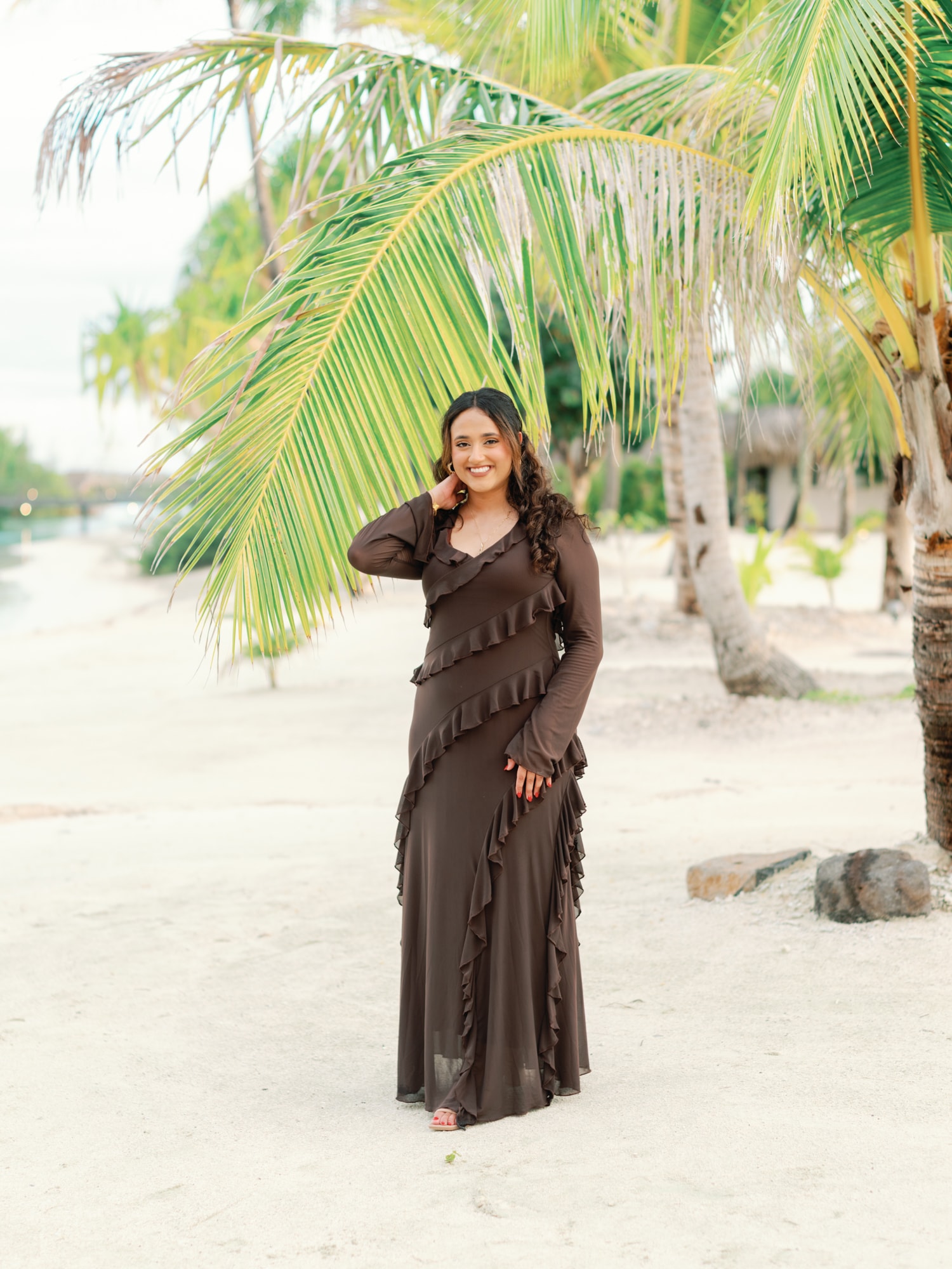 Woman portrait in the palms on the beach of Bora Bora
